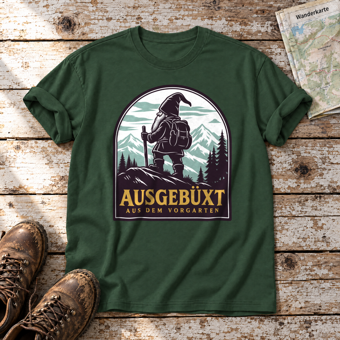 Ausgebüxt aus dem Vorgarten – T-Shirt Unisex in Flaschengrün, flach liegend auf alten Holzbrettern mit Wanderschuhen und Wanderkarte.
