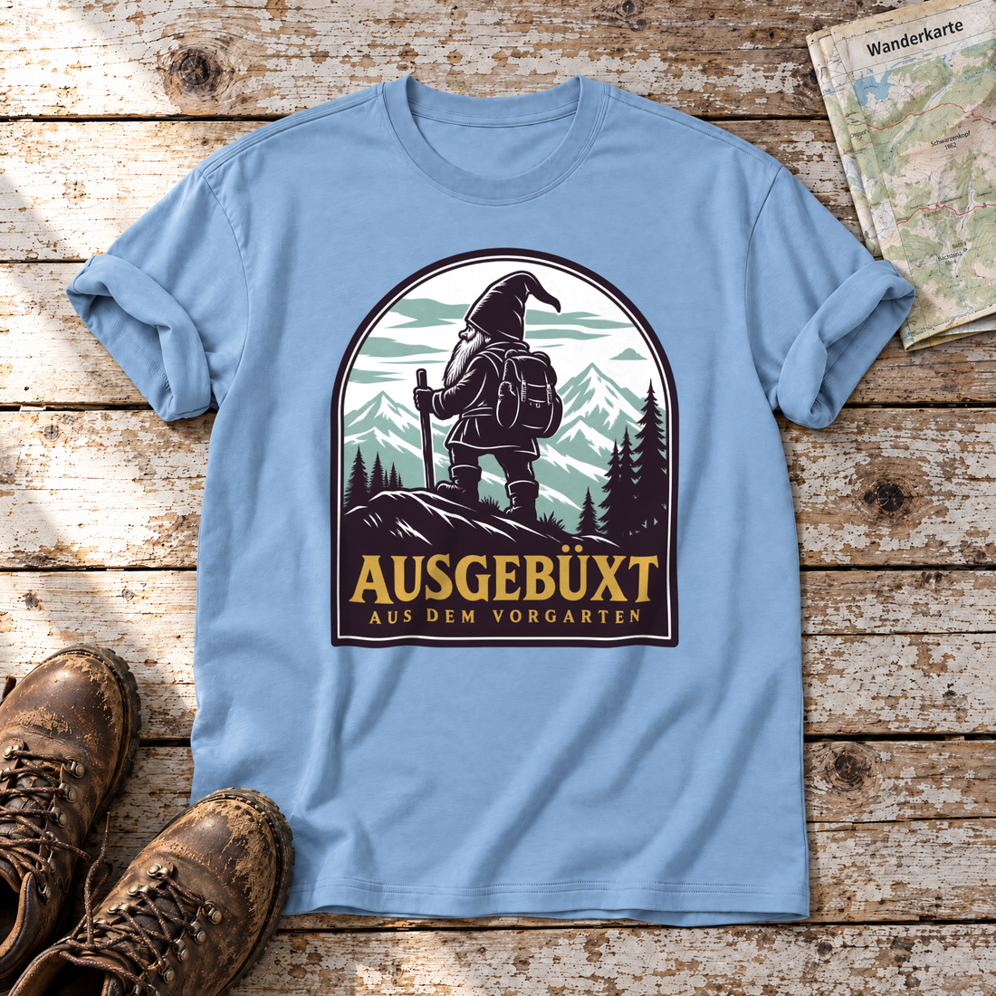 Ausgebüxt aus dem Vorgarten – T-Shirt Unisex in Himmelblau, flach liegend auf alten Holzbrettern mit Wanderschuhen und Wanderkarte.