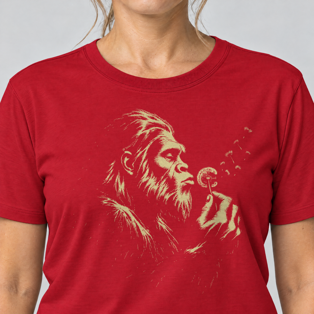Nahaufnahme des Drucks: Bigfoot mit Pusteblume – T-Shirt Unisex in Rot, von einer Frau getragen