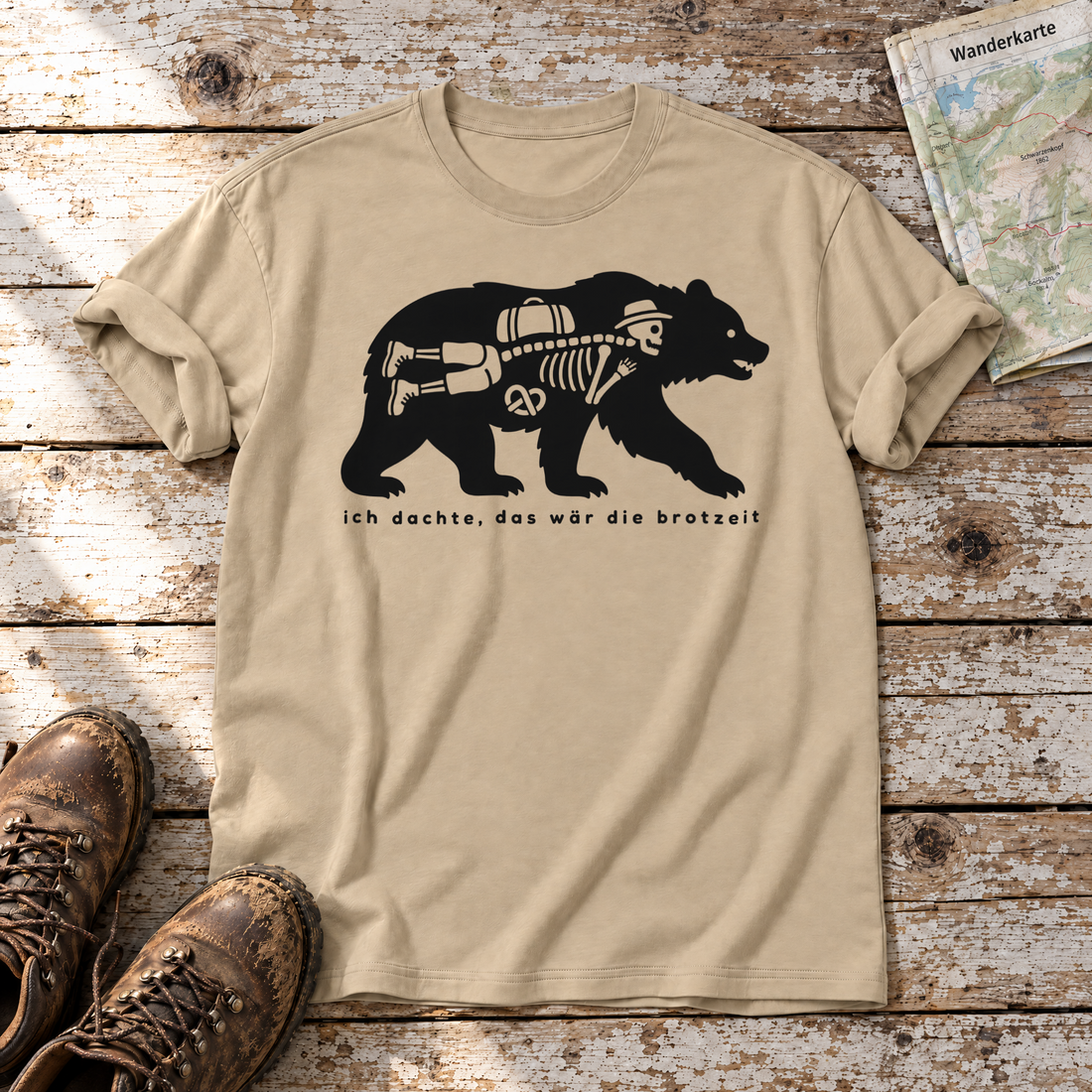 Das wär die Brotzeit – T-Shirt Unisex in Sand, flach liegend auf alten Holzbrettern mit Wanderschuhen und Wanderkarte.