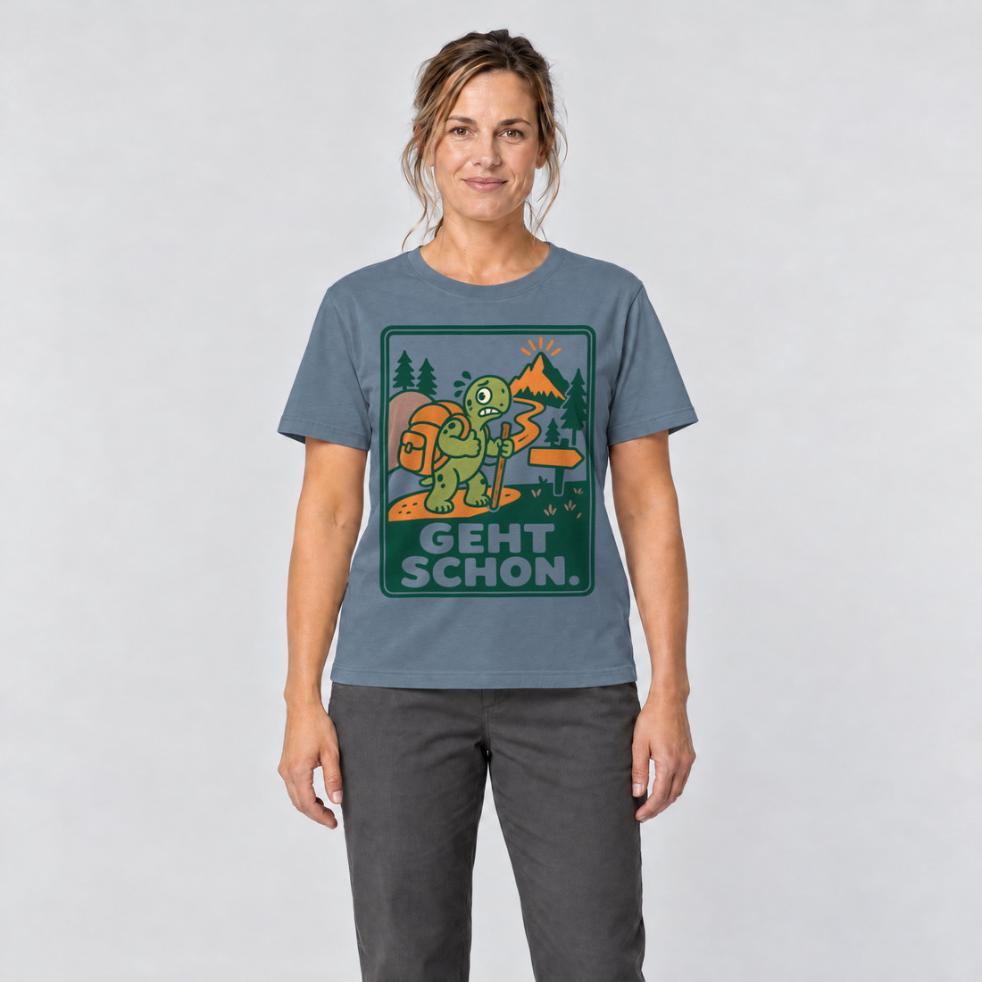 Frau trägt Geht schon – T-Shirt Unisex in Steinblau, Ansicht von vorn