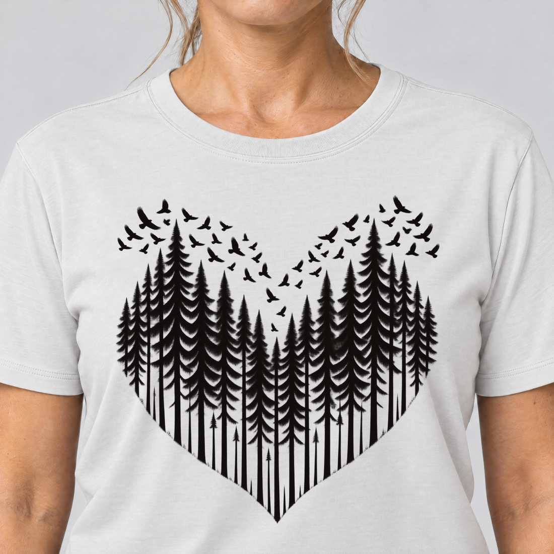 Nahaufnahme des Drucks: Bergwald-Herz mit Alpendohlen – T-Shirt Unisex in Weiß, von einer Frau getragen