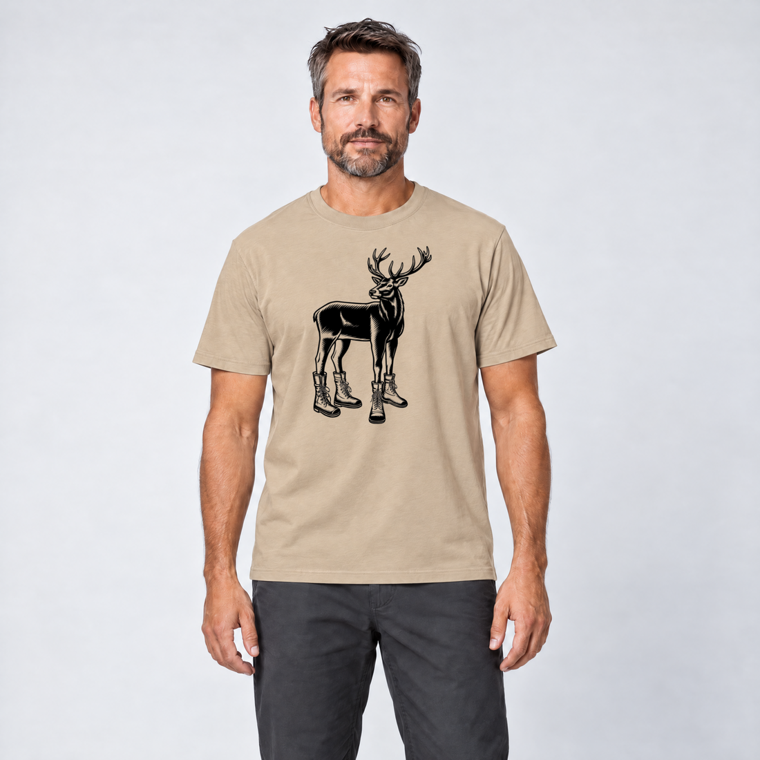 Mann trägt Hirsch in Bergschuhen – T-Shirt Unisex in Sand, Ansicht von vorn