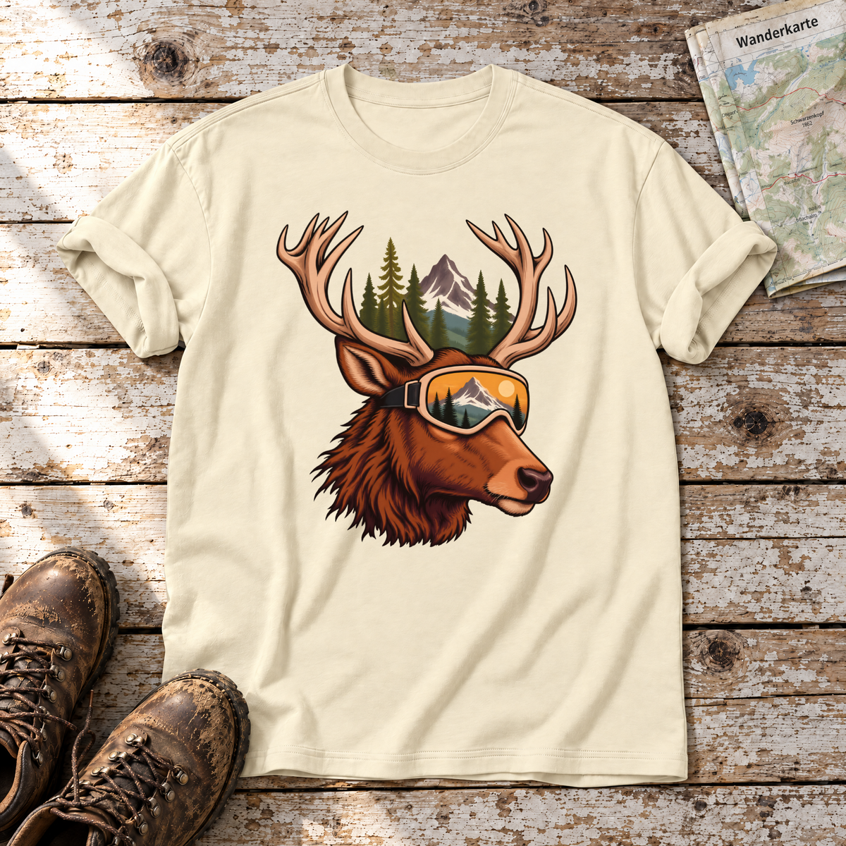 Hirsch mit Skibrille – T-Shirt Unisex in Natur, flach liegend auf alten Holzbrettern mit Wanderschuhen und Wanderkarte.
