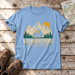 Bankgeheimnis – T-Shirt Unisex in Himmelblau, flach liegend auf alten Holzbrettern mit Wanderschuhen und Wanderkarte.