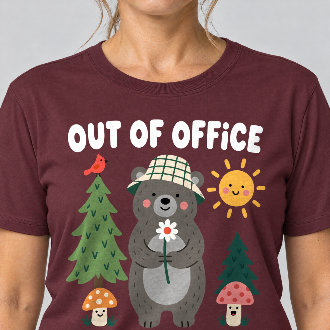 Nahaufnahme des Drucks: Out of Office – into the Woods – T-Shirt Unisex in Bordeaux, von einer Frau getragen