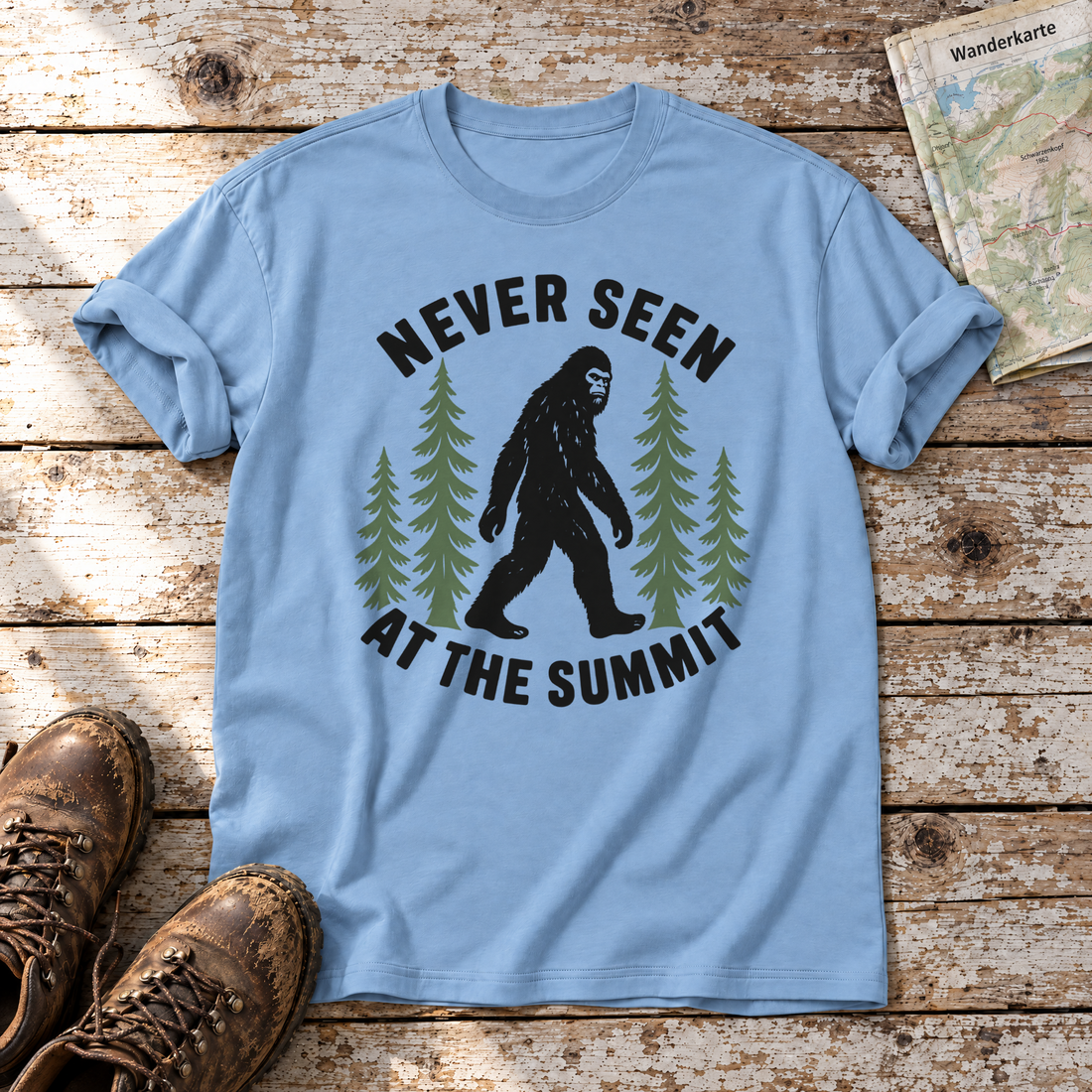 Never seen at the summit – T-Shirt Unisex in Himmelblau, flach liegend auf alten Holzbrettern mit Wanderschuhen und Wanderkarte.