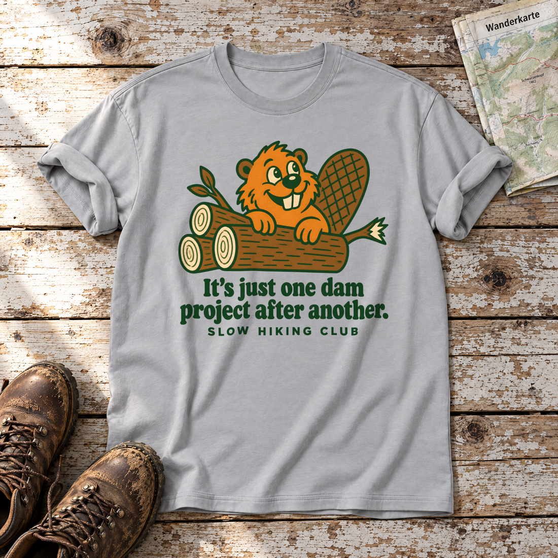 One dam project after another – T-Shirt Unisex in Hellgrau, flach liegend auf alten Holzbrettern mit Wanderschuhen und Wanderkarte.