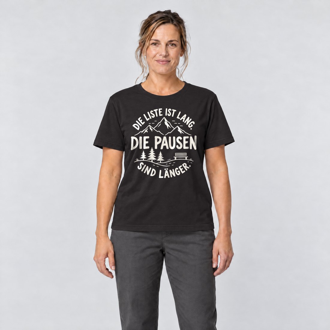 Frau trägt Die Pausen sind länger – T-Shirt Unisex in Schwarz, Ansicht von vorn