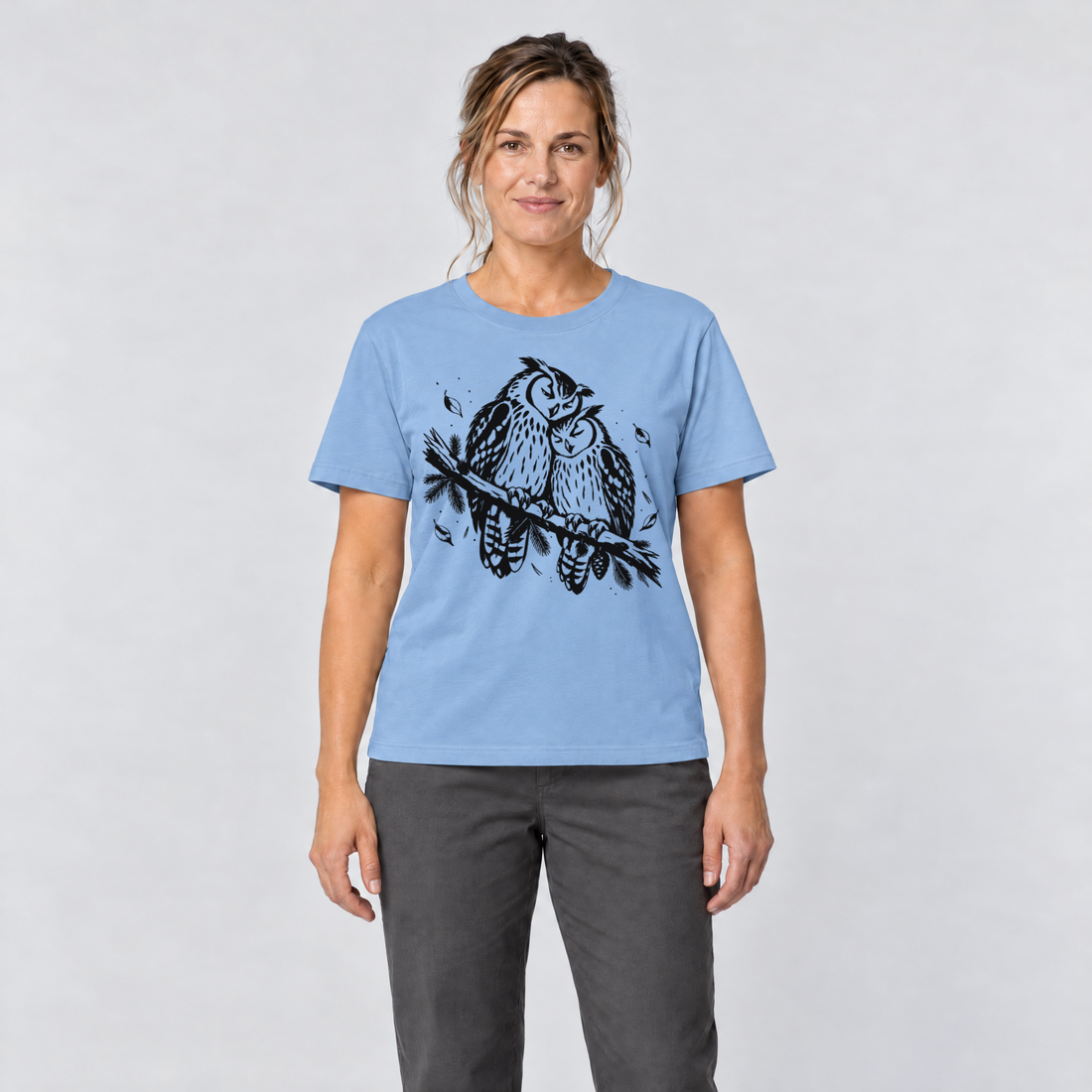 Frau trägt Uhupaar auf dem Fichtenast – T-Shirt Unisex in Himmelblau, Ansicht von vorn