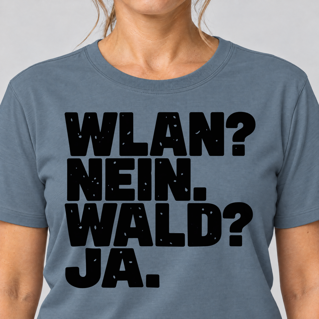 Nahaufnahme des Drucks: WLAN? Nein. Wald? Ja. – T-Shirt Unisex in Steinblau, von einer Frau getragen