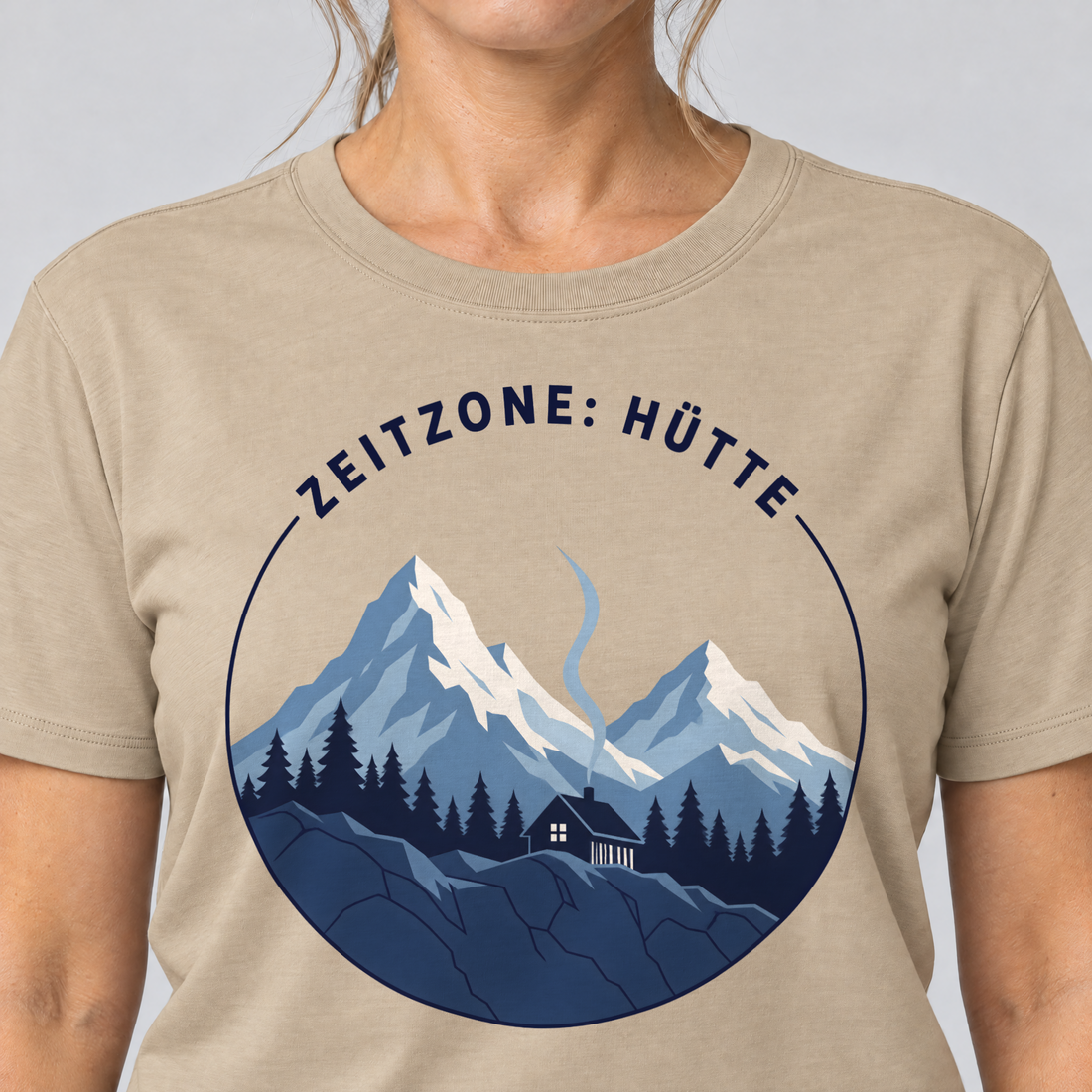 Nahaufnahme des Drucks: Zeitzone: Hütte – T-Shirt Unisex in Sand, von einer Frau getragen